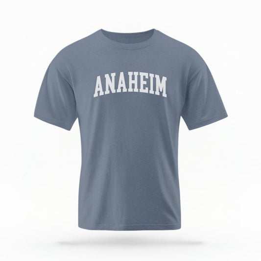 The Blue Jean Unisex Anaheim CA Varsity T-shirt is set against a Ghost - White Studio background. The Anaheim CA Varsity graphic is in a Varsity style.