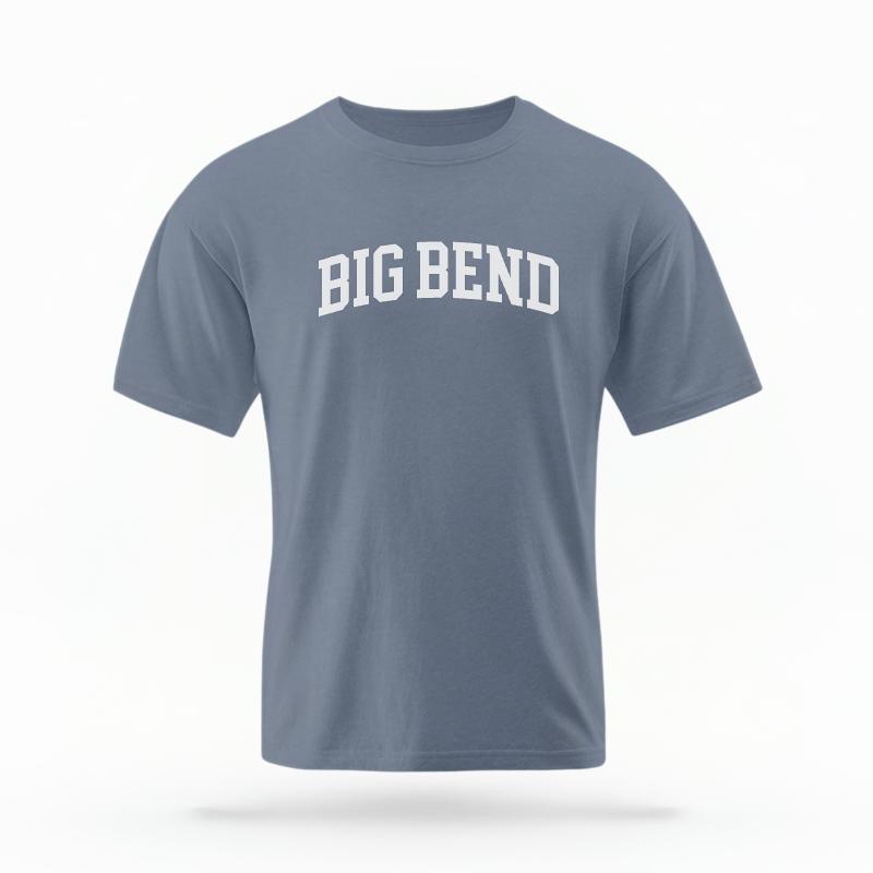 The Blue Jean Unisex Big Bend Varsity T-shirt is set against a Ghost - White Studio background. The Big Bend Varsity graphic is in a Varsity style.