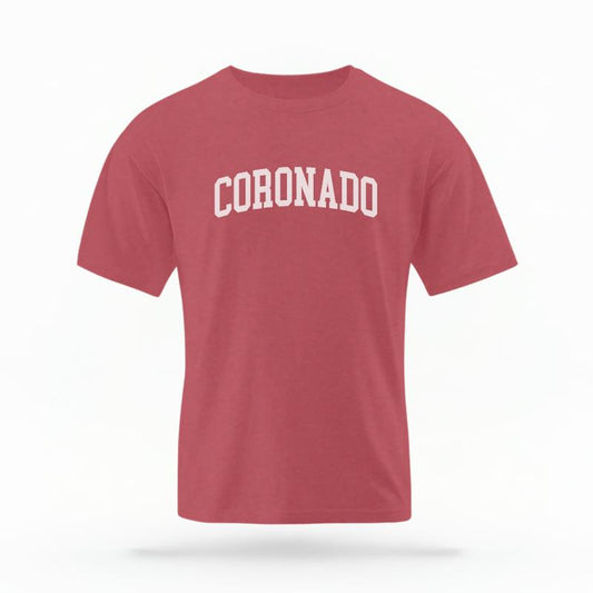 The Crimson Unisex Coronado CA Varsity T-shirt is set against a Ghost - White Studio background. The Coronado CA Varsity graphic is in a Varsity style.