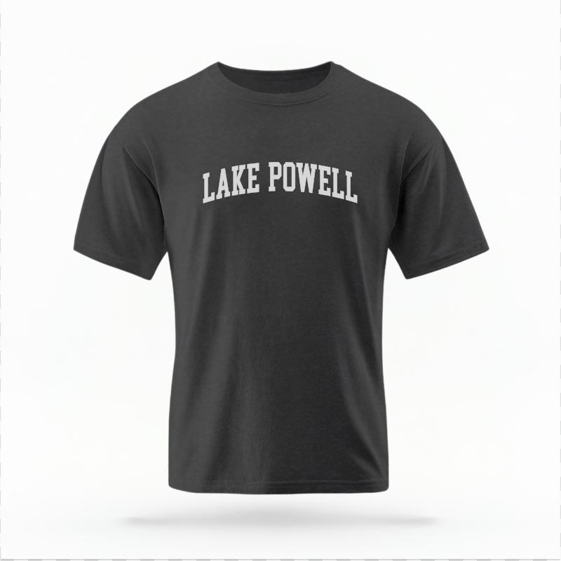 The Pepper Unisex Lake Powell AZ Varsity T-shirt is set against a Ghost - White Studio background. The Lake Powell AZ Varsity graphic is in a Varsity style.