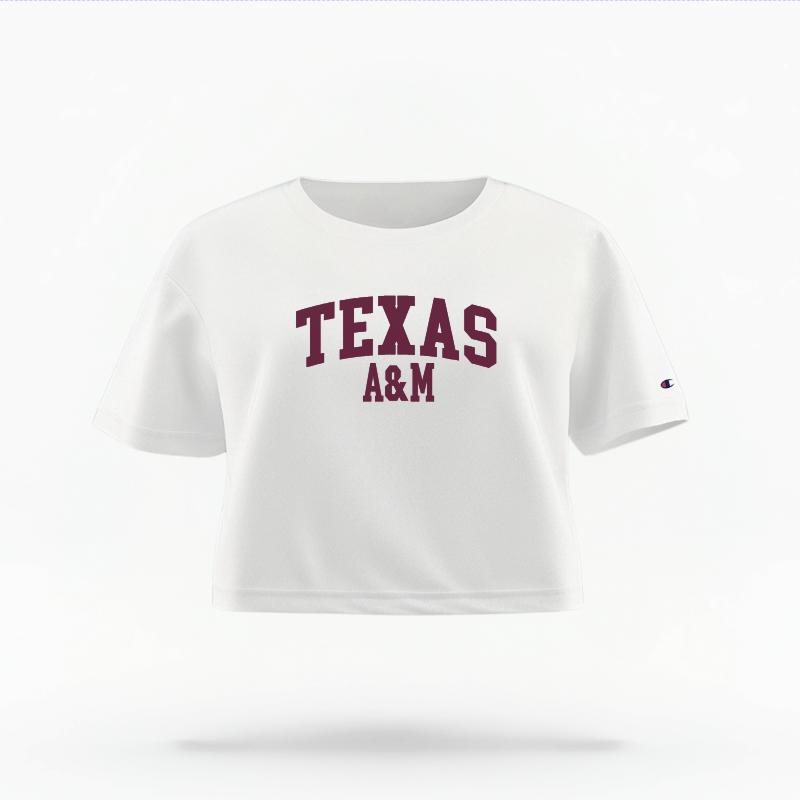The White Female Texas A&M Varsity Women's Boxy Crop Top is set against a Ghost - White Studio background. The Texas A&M Varsity graphic is in a Sports Graphics style.