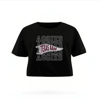 The Black Female Aggies Pennant Women's Boxy Crop Top is set against a Ghost - White Studio background.  The Aggies Pennant graphic is in a Sports Graphics style. 