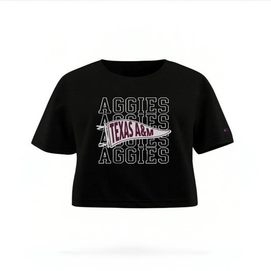 The Black Female Aggies Pennant Women's Boxy Crop Top is set against a Ghost - White Studio background.  The Aggies Pennant graphic is in a Sports Graphics style. 