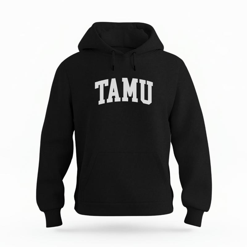 The Black Unisex TAMU Varsity Organic Cotton Hoodie is set against a Ghost - White Studio background.  The TAMU Varsity graphic is in a Sports Graphics style. 