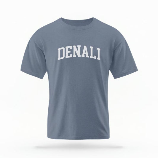 The Blue Jean Unisex Denali Alaska Varsity T-shirt is set against a Ghost - White Studio background.  The Denali Alaska Varsity graphic is in a Varsity style. 