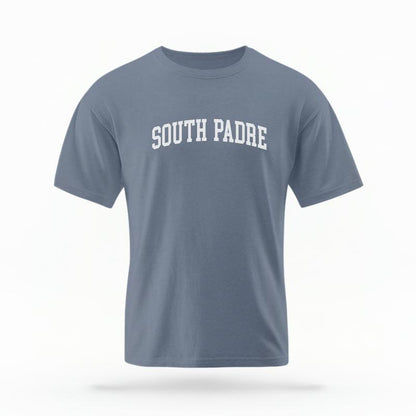 The Blue Jean Unisex South Padre Varsity T-shirt is set against a Ghost - White Studio background.  The South Padre Varsity graphic is in a Varsity style. 