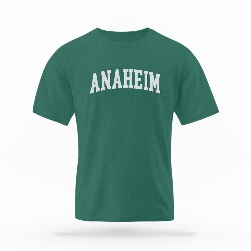 The Blue Spruce Unisex Anaheim CA Varsity T-shirt is set against a Ghost - White Studio background.  The Anaheim CA Varsity graphic is in a Varsity style. 