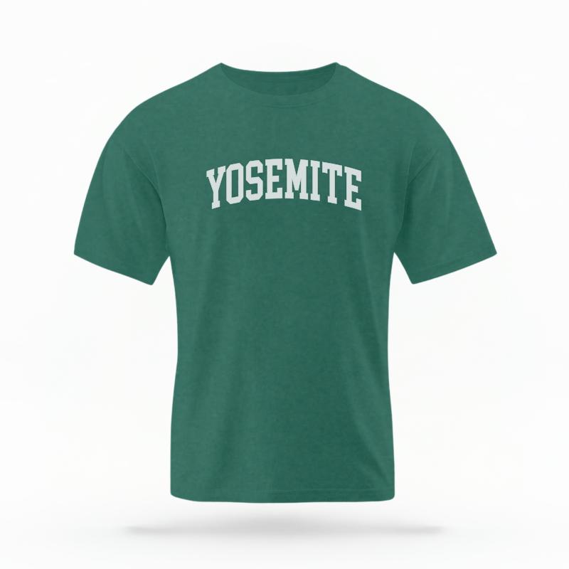 The Blue Spruce Unisex Yosemite CA Varsity T-shirt is set against a Ghost - White Studio background.  The Yosemite CA Varsity graphic is in a Varsity style. 