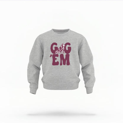 The Heather Grey Unisex Gig 'Em Retro Reveille Toddler Crewneck is set against a Ghost - White Studio background.  The Gig 'Em Retro Reveille graphic is in a Sports Graphics style. 