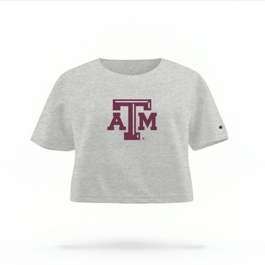 The Heather Grey Female Texas A&M Logo Women's Boxy Crop Top is set against a Ghost - White Studio background.  The Texas A&M Logo graphic is in a Logo style. 