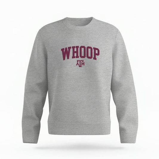 The Heather Grey Unisex Whoop Varsity Organic Cotton Crewneck is set against a Ghost - White Studio background.  The Whoop Varsity graphic is in a Sports Graphics style. 