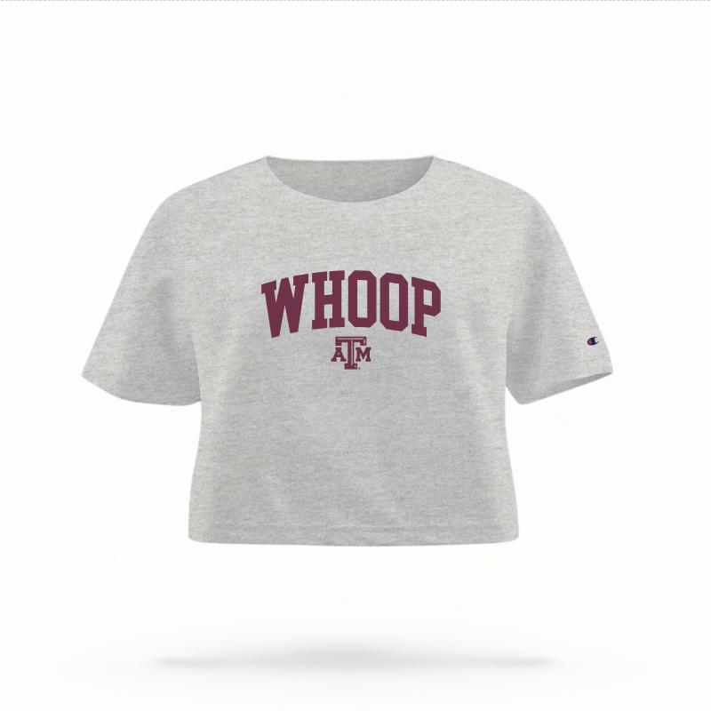 The Heather Grey Female Whoop Varsity Women's Boxy Crop Top is set against a Ghost - White Studio background.  The Whoop Varsity graphic is in a Sports Graphics style. 