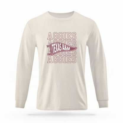 The Ivory Unisex Aggies Pennant Long Sleeve T-shirt is set against a Ghost - White Studio background.  The Aggies Pennant graphic is in a Sports Graphics style. 