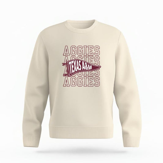 The Ivory Unisex Aggies Pennant Organic Cotton Crewneck is set against a Ghost - White Studio background.  The Aggies Pennant graphic is in a Sports Graphics style. 