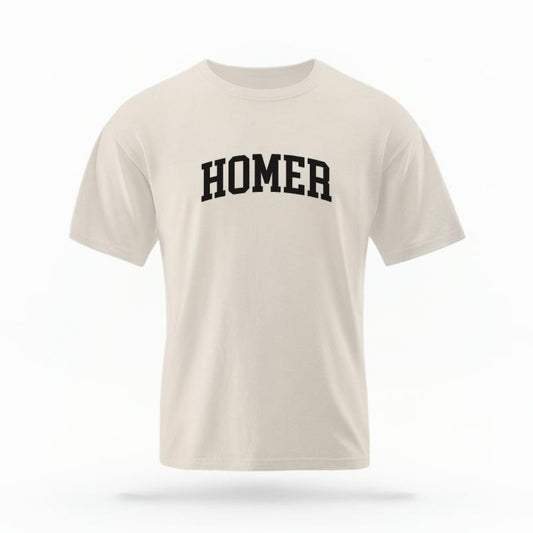 The Ivory Unisex Homer Alaska Varsity T-shirt is set against a Ghost - White Studio background.  The Homer Alaska Varsity graphic is in a Varsity style. 