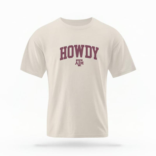 The Ivory Unisex Howdy Varsity T-shirt is set against a Ghost - White Studio background.  The Howdy Varsity graphic is in a Varsity style. 