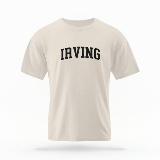 The Ivory Unisex Irving Varsity T-shirt is set against a Ghost - White Studio background.  The Irving Varsity graphic is in a Varsity style. 
