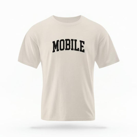 The Ivory Unisex Mobile, AL Varsity T-shirt is set against a Ghost - White Studio background.  The Mobile, AL Varsity graphic is in a Varsity style. 