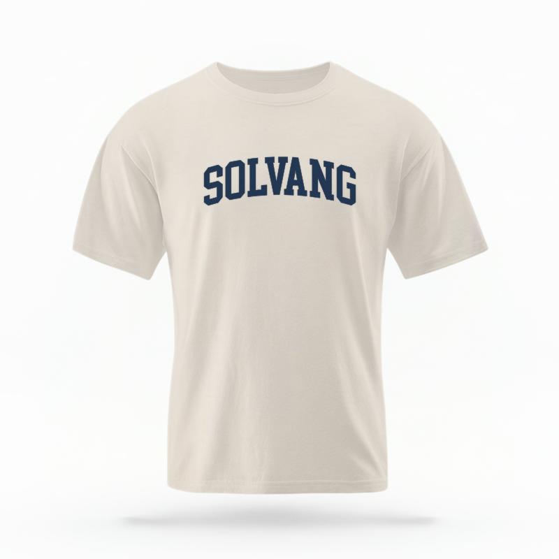 The Ivory Unisex Solvang CA Varsity T-shirt is set against a Ghost - White Studio background.  The Solvang CA Varsity graphic is in a Varsity style. 