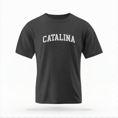 The Pepper Unisex Catalina CA Varsity T-shirt is set against a Ghost - White Studio background.  The Catalina CA Varsity graphic is in a Varsity style. 