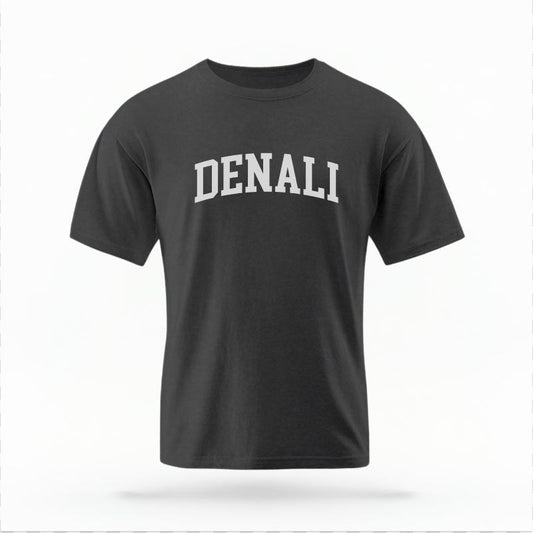 The Pepper Unisex Denali Alaska Varsity T-shirt is set against a Ghost - White Studio background.  The Denali Alaska Varsity graphic is in a Varsity style. 