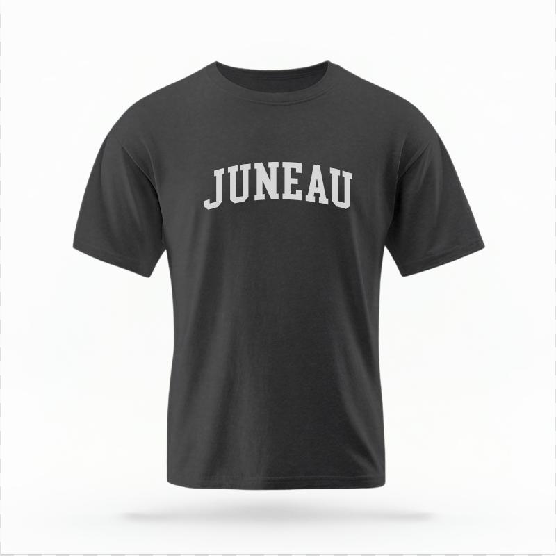 The Pepper Unisex Juneau Alaska Varsity T-shirt is set against a Ghost - White Studio background.  The Juneau Alaska Varsity graphic is in a Varsity style. 
