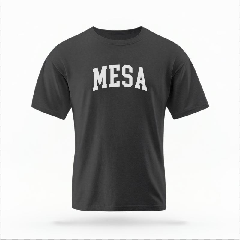 The Pepper Unisex Mesa AZ Varsity T-shirt is set against a Ghost - White Studio background.  The Mesa AZ Varsity graphic is in a Varsity style. 