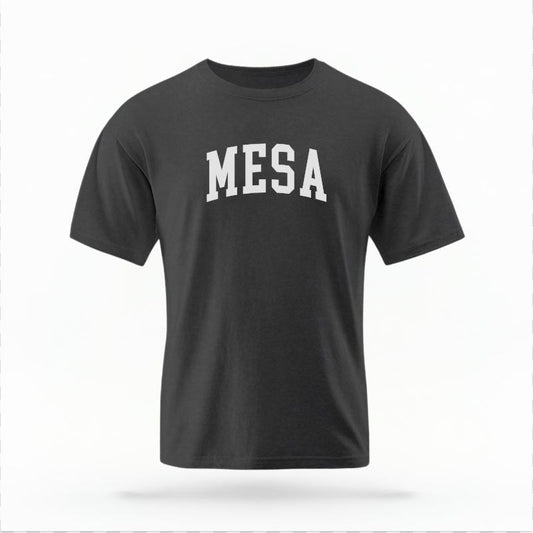 The Pepper Unisex Mesa AZ Varsity T-shirt is set against a Ghost - White Studio background.  The Mesa AZ Varsity graphic is in a Varsity style. 
