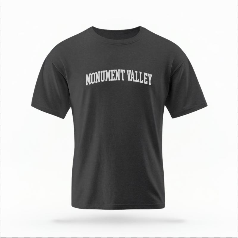 The Pepper Unisex Monument Valley AZ Varsity T-shirt is set against a Ghost - White Studio background.  The Monument Valley AZ Varsity graphic is in a Varsity style. 