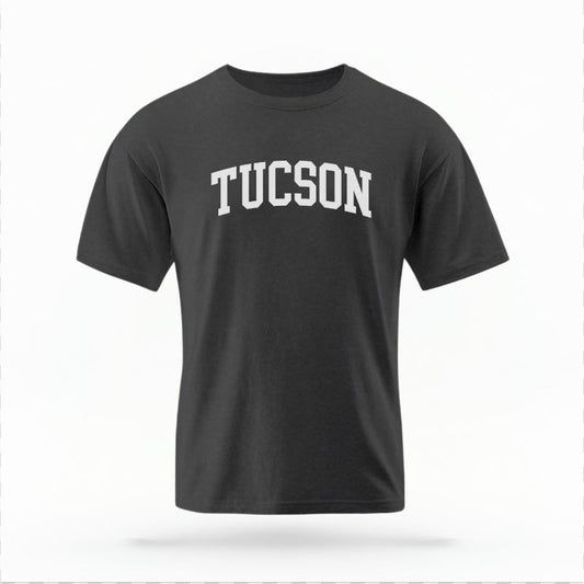 The Pepper Unisex Tucson AZ Varsity T-shirt is set against a Ghost - White Studio background.  The Tucson AZ Varsity graphic is in a Varsity style. 