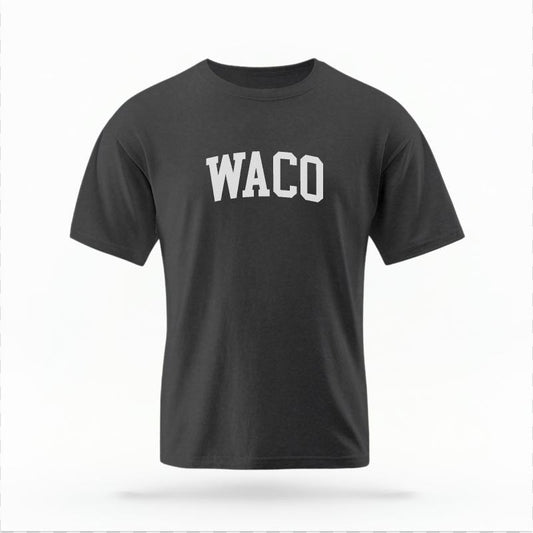 The Pepper Unisex Waco Varsity T-shirt is set against a Ghost - White Studio background.  The Waco Varsity graphic is in a Varsity style. 