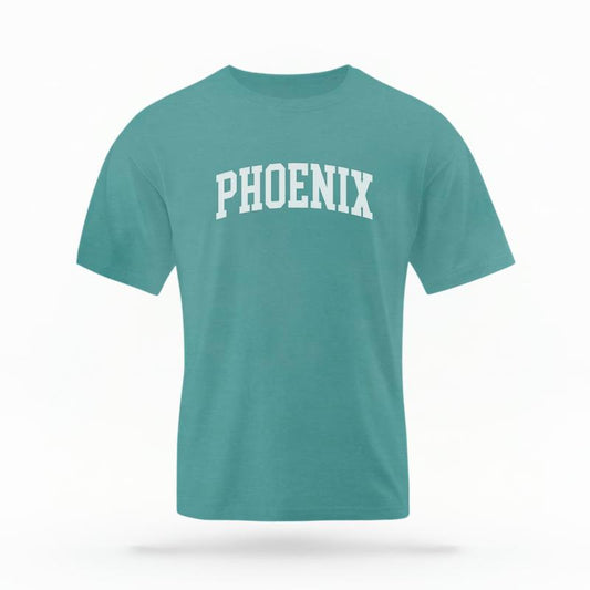 The Seafoam Unisex Phoenix AZ Varsity T-shirt is set against a Ghost - White Studio background.  The Phoenix AZ Varsity graphic is in a Varsity style. 