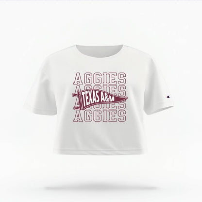 The White Female Aggies Pennant Women's Boxy Crop Top is set against a Ghost - White Studio background.  The Aggies Pennant graphic is in a Sports Graphics style. 