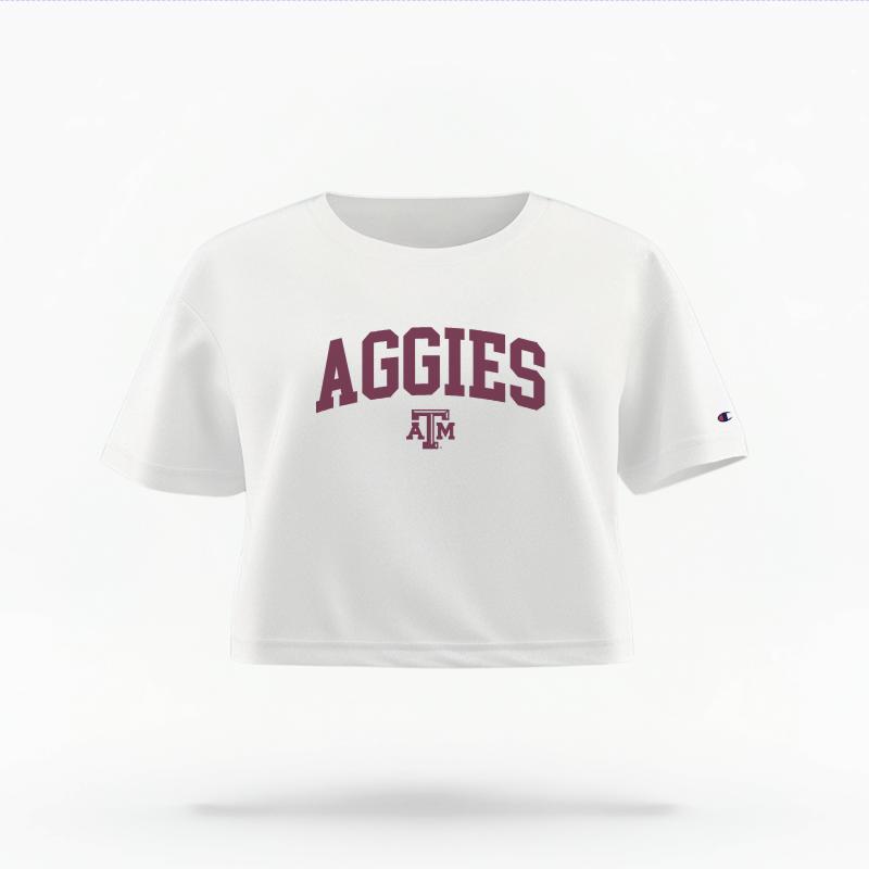 The White Female Aggies Varsity Women's Boxy Crop Top is set against a Ghost - White Studio background.  The Aggies Varsity graphic is in a Sports Graphics style. 