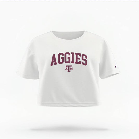 The White Female Aggies Varsity Women's Boxy Crop Top is set against a Ghost - White Studio background.  The Aggies Varsity graphic is in a Sports Graphics style. 