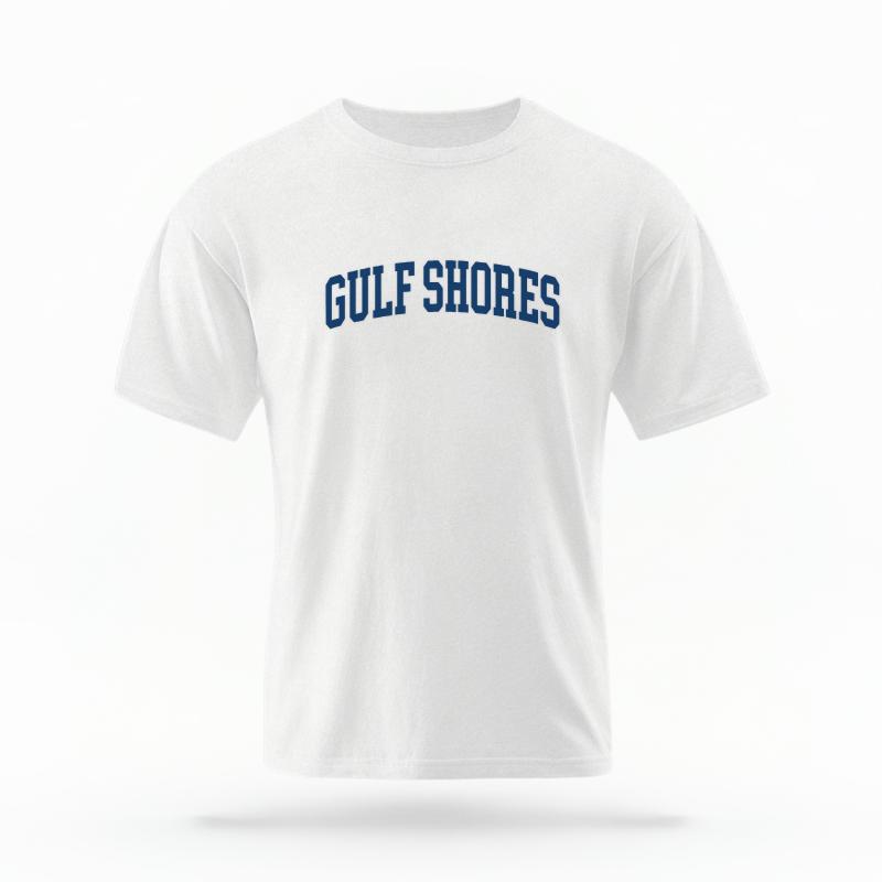 The White Unisex Gulf Shores, AL Varsity T-shirt is set against a Ghost - White Studio background.  The Gulf Shores, AL Varsity graphic is in a Varsity style. 