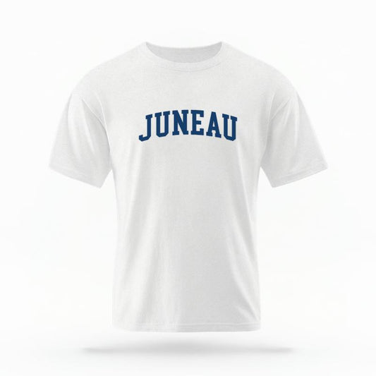 The White Unisex Juneau Alaska Varsity T-shirt is set against a Ghost - White Studio background.  The Juneau Alaska Varsity graphic is in a Varsity style. 