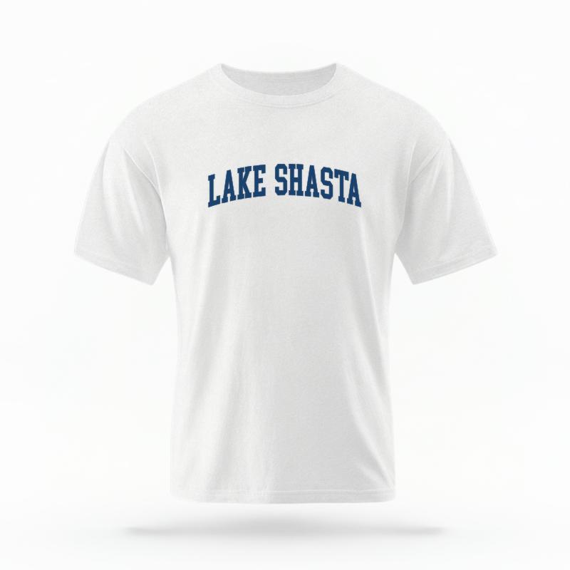 The White Unisex Lake Shasta CA Varsity T-shirt is set against a Ghost - White Studio background.  The Lake Shasta CA Varsity graphic is in a Varsity style. 
