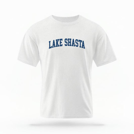 The White Unisex Lake Shasta CA Varsity T-shirt is set against a Ghost - White Studio background.  The Lake Shasta CA Varsity graphic is in a Varsity style. 