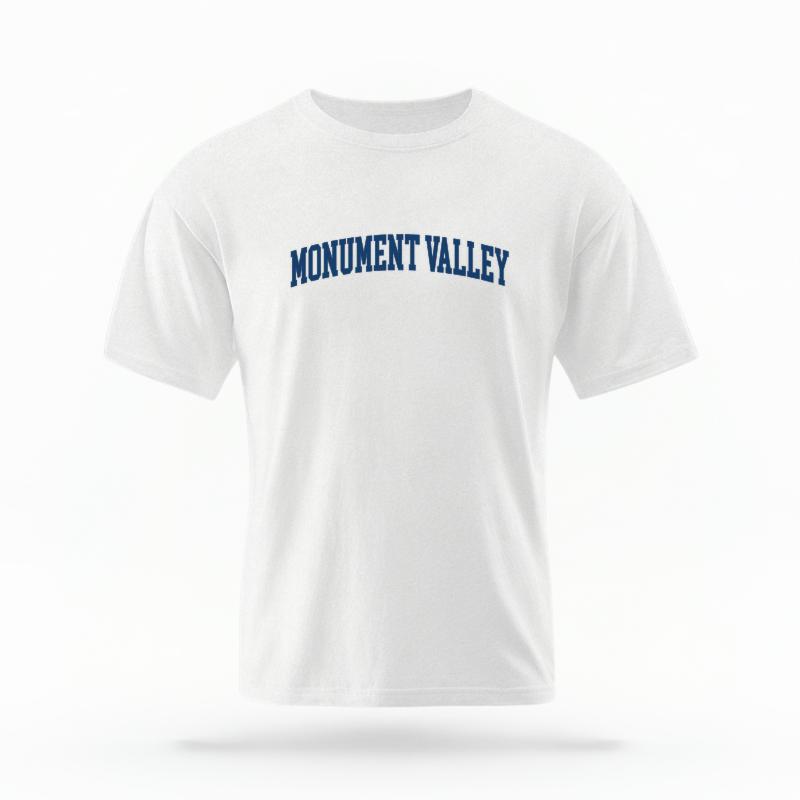 The White Unisex Monument Valley AZ Varsity T-shirt is set against a Ghost - White Studio background.  The Monument Valley AZ Varsity graphic is in a Varsity style. 