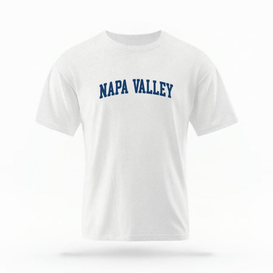 The White Unisex Napa Valley CA Varsity T-shirt is set against a Ghost - White Studio background.  The Napa Valley CA Varsity graphic is in a Varsity style. 
