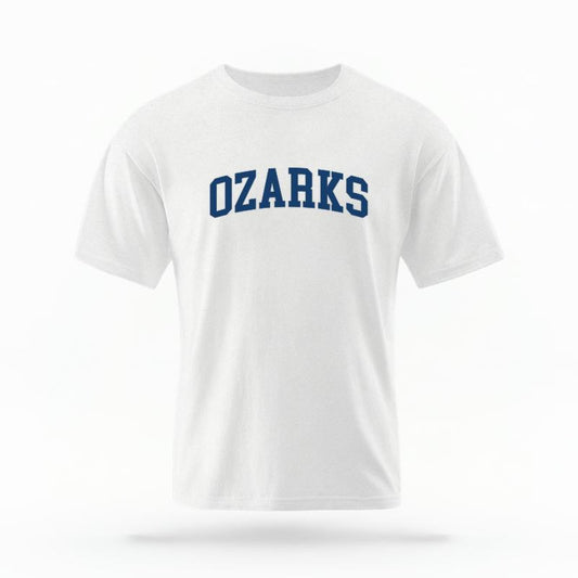 The White Unisex Ozarks AR Varsity T-shirt is set against a Ghost - White Studio background.  The Ozarks AR Varsity graphic is in a Varsity style. 