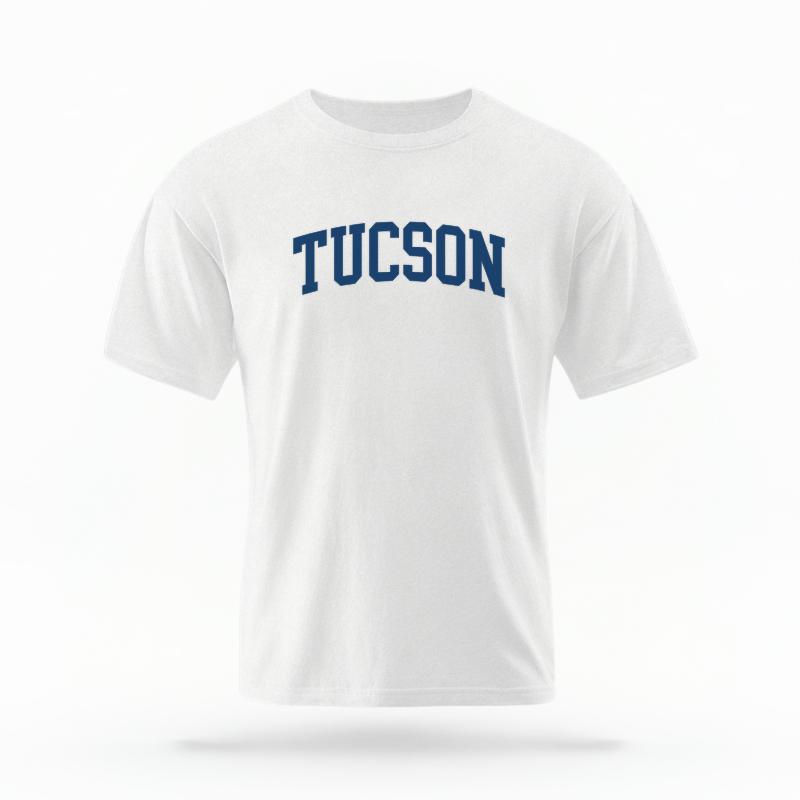 The White Unisex Tucson AZ Varsity T-shirt is set against a Ghost - White Studio background.  The Tucson AZ Varsity graphic is in a Varsity style. 